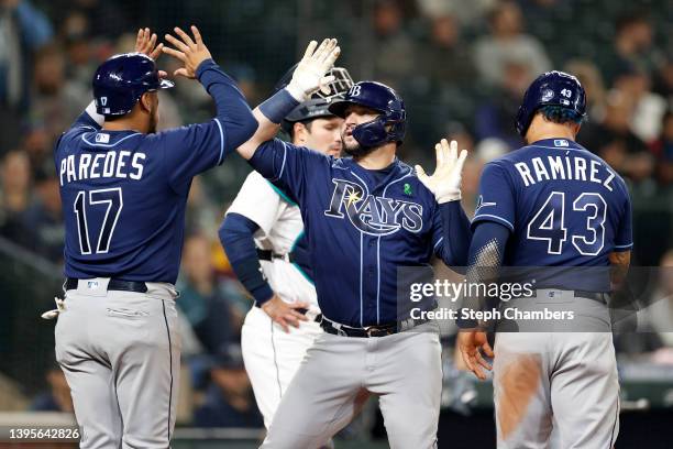 Mike Zunino of the Tampa Bay Rays celebrates his three run home run with Isaac Paredes and Harold Ramirez during the fourth inning against the...