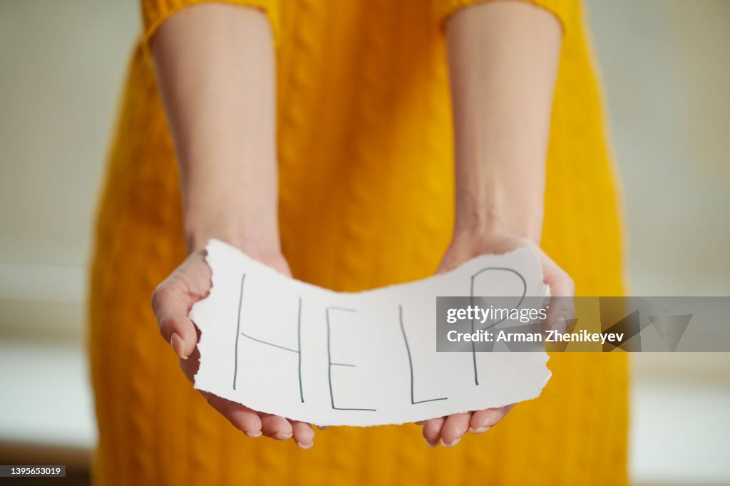 Help Sign On Paper Woman Holding Paper Sign With Help Text High-Res Stock Photo - Getty Images
