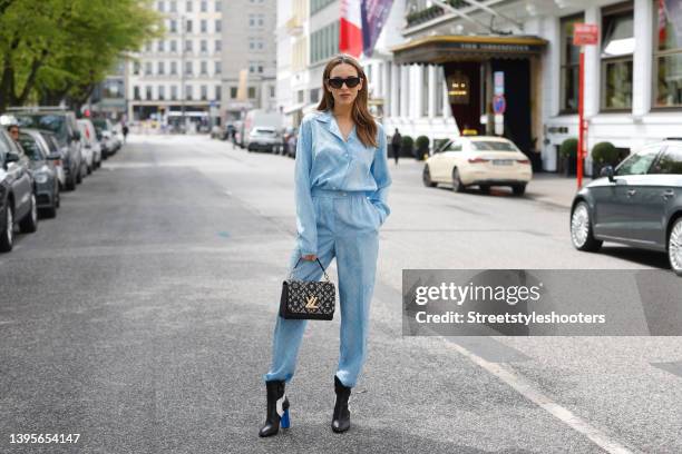 Influencer Alexandra Lapp wearing a bleu oxford colored cloud monogram jumpsuit pyjama by Louis Vuitton, blue, black and white silhouette ankle boots...