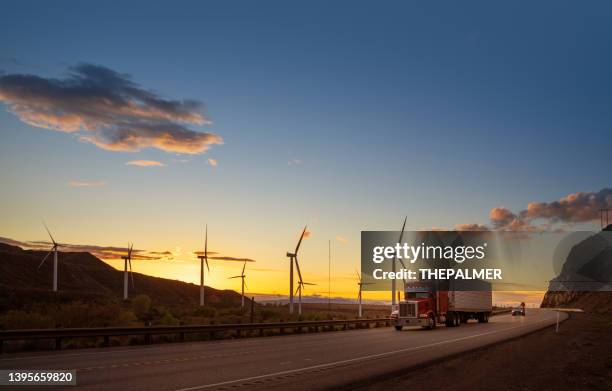 semi truck speeding in front of wind turbines in usa - air freight transportation stock pictures, royalty-free photos & images