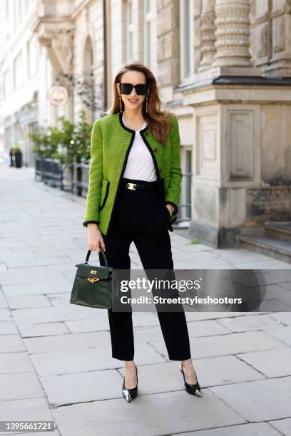 Influencer Alexandra Lapp wearing a light green vintage jacket by Saint Laurent, a white tank top by Mango, black pants by Max Mara, a dark green...