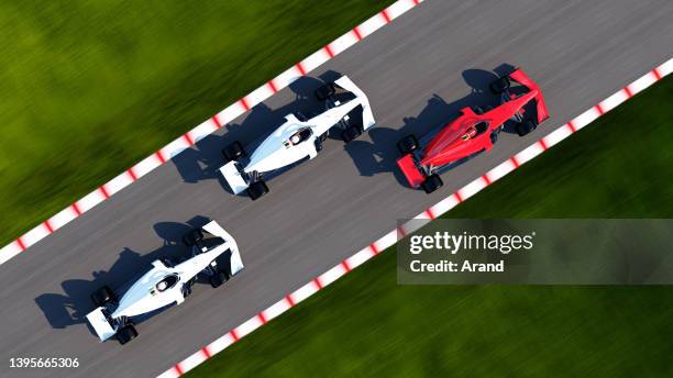 red race car leading on a race track - racewagen stockfoto's en -beelden