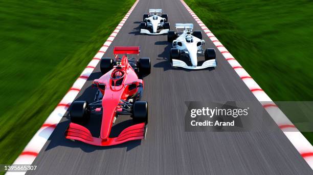 red race car leading on a race track - motor racing track aerial stock pictures, royalty-free photos & images