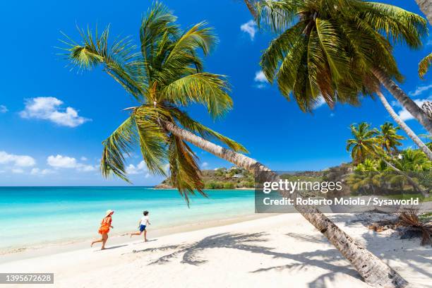 cute little boy with mother having fun running on a beach - barbados stock pictures, royalty-free photos & images