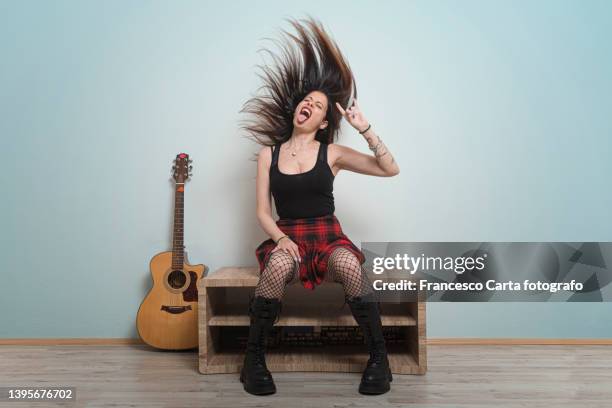 hipster adult woman singing and screaming - punk person stock-fotos und bilder