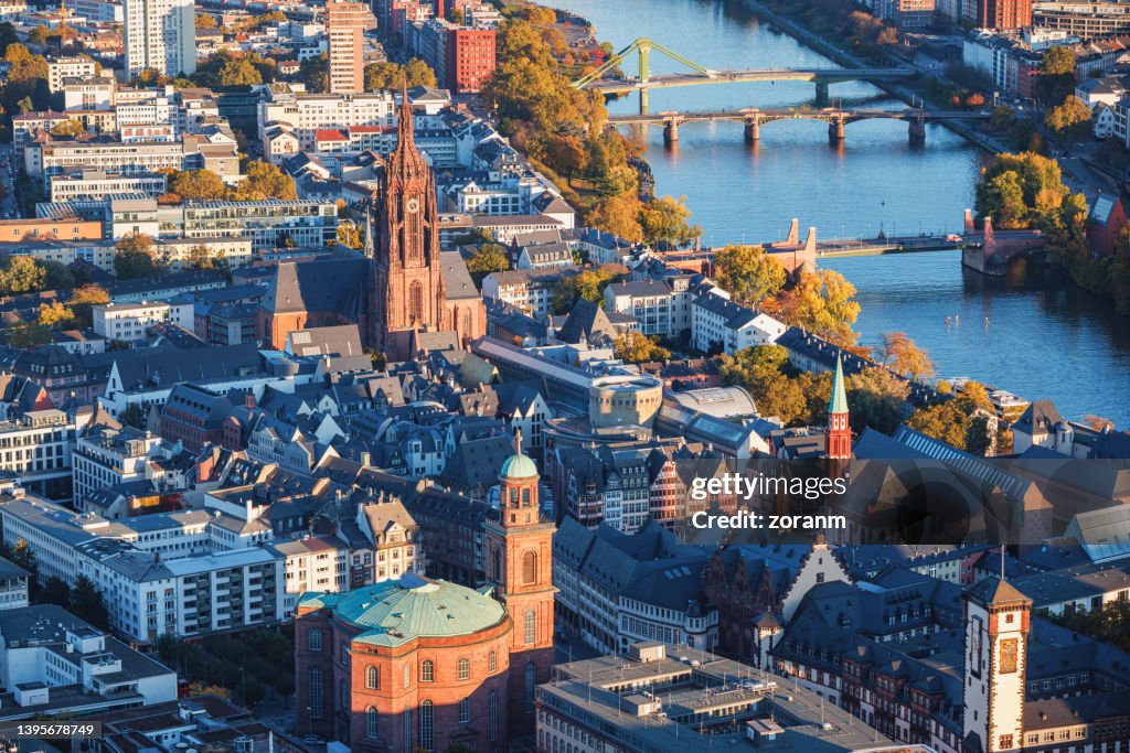 Aerial view on the Main riverbank with Frankfurt cathedral among buildings