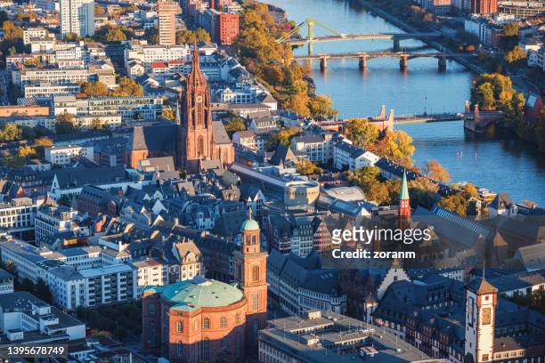 aerial view on the main riverbank with frankfurt cathedral among buildings - hesse germany stock pictures, royalty-free photos & images