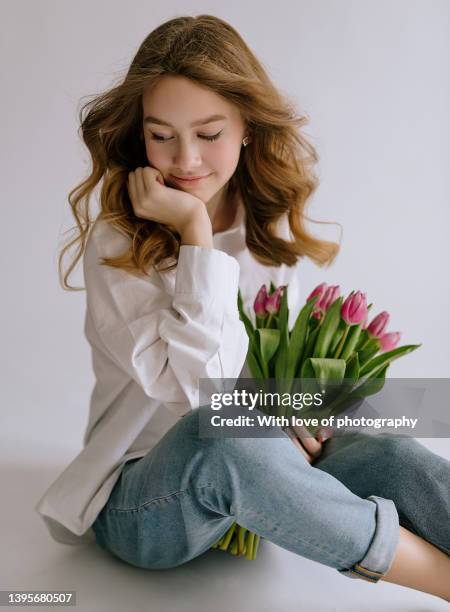 cute teenager girl 14-16 years old european school girl with tulips - 12 13 14 15 years girl stock pictures, royalty-free photos & images