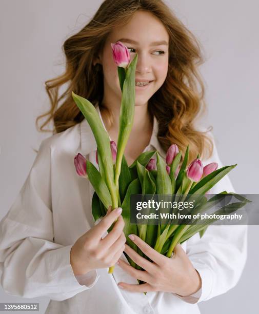 cute teenager girl 14-16 years old european school girl with tulips - 12 13 14 15 years girl stock pictures, royalty-free photos & images