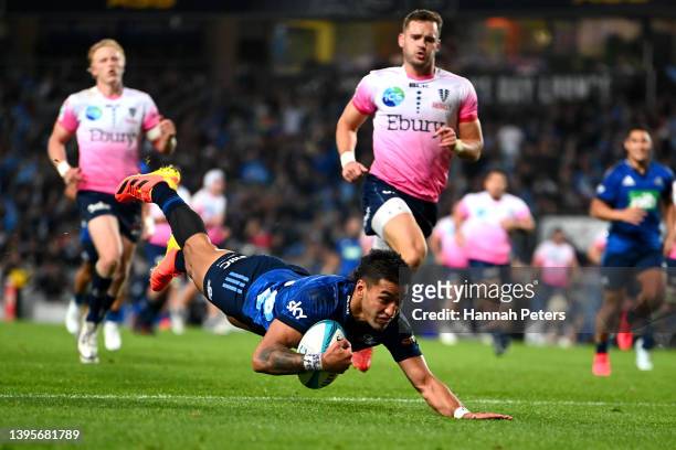 Rieko Ioane of the Blues dives over to score a try during the round 12 Super Rugby Pacific match between the Blues and the Melbourne Rebels at Eden...