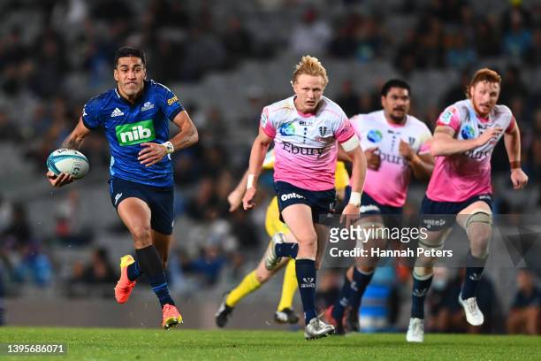 Rieko Ioane of the Blues makes a break during the round 12 Super Rugby Pacific match between the Blues and the Melbourne Rebels at Eden Park on May...