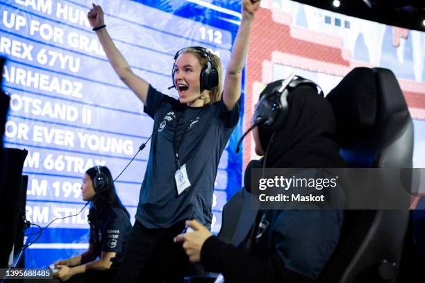 cheerful woman screaming while winning online video game during esports tournament - esports stock pictures, royalty-free photos & images