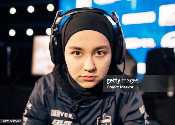 portrait of female gamer with serious face wearing headset at esports arena - islamic front member stock pictures, royalty-free photos & images