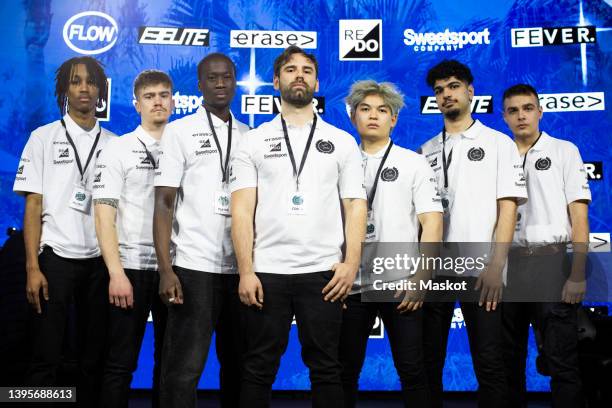 portrait of confident male gamers and coach standing against sponsor logos at esports arena - baby logo stock pictures, royalty-free photos & images