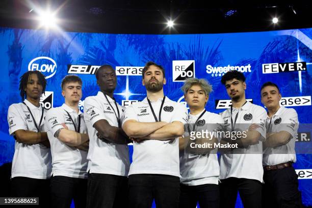 confident male gamers and coach with arms crossed at esports competition - sport sponsorship stock pictures, royalty-free photos & images