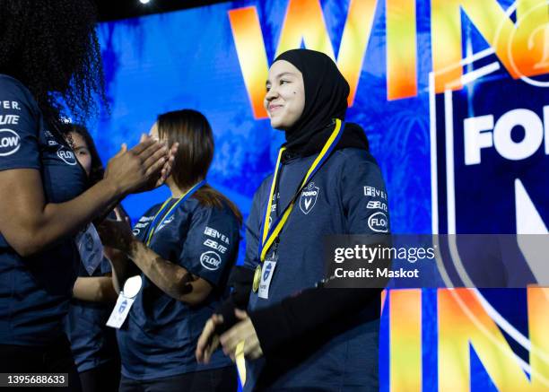 mature female coach clapping for gamers winning esports championship at arena - esports stock pictures, royalty-free photos & images