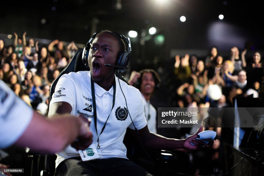 Male gamer shaking hand after winning eSports competition