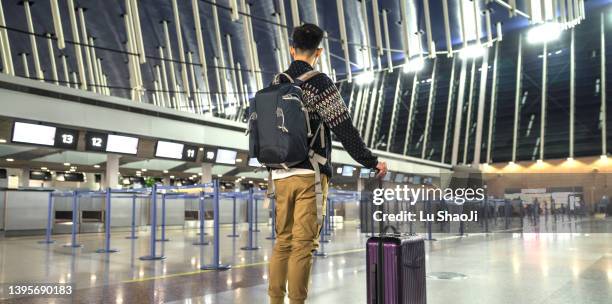 passengers are waiting at the airport terminal. - global entry stock pictures, royalty-free photos & images