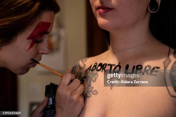 Member of Femen paints the phrase 'Free abortion' in Spanish on the chest of other member of Femen on May 06, 2022 in Madrid, Spain. Femen activists...