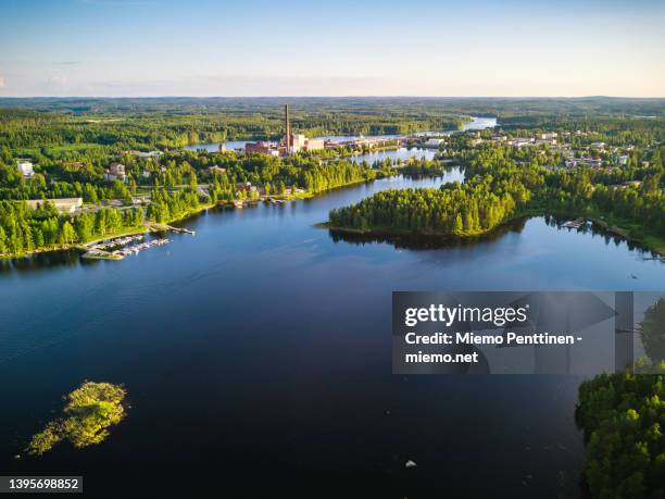 aerial view over a small finnish town with a factory on lakeside on a sunny summer day - lake finland bildbanksfoton och bilder