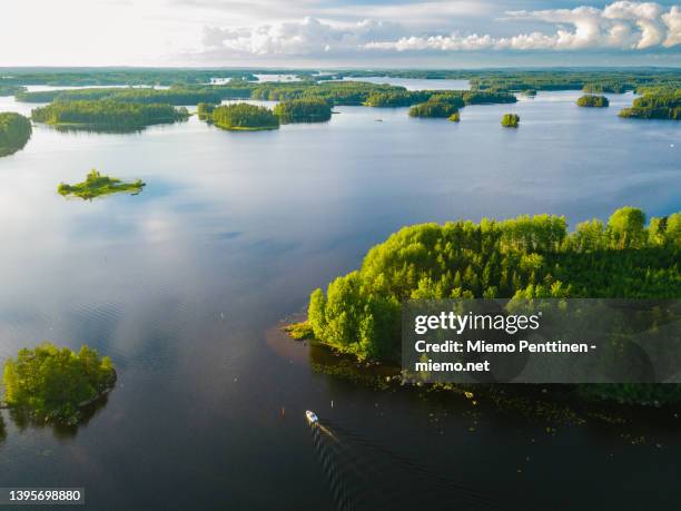 aerial view of archipelago in the finnish lake district in summertime with a small solitary boat in the foreground - arquipélago imagens e fotografias de stock