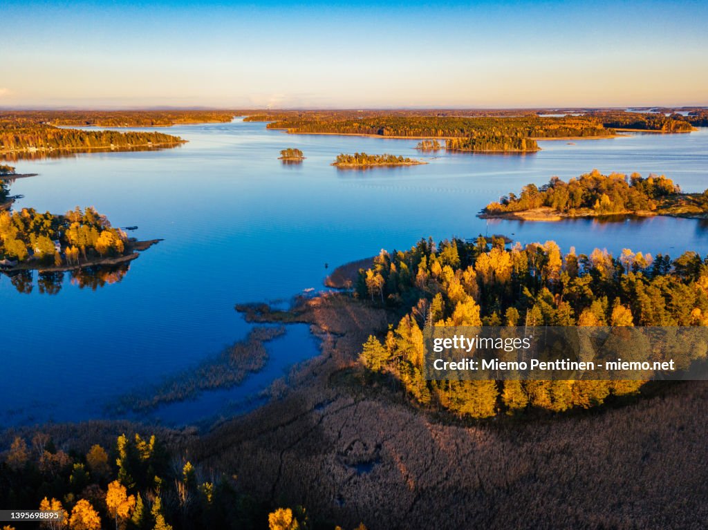 Aerial view over autumnal coastal area near Helsinki, Finland during golden hour