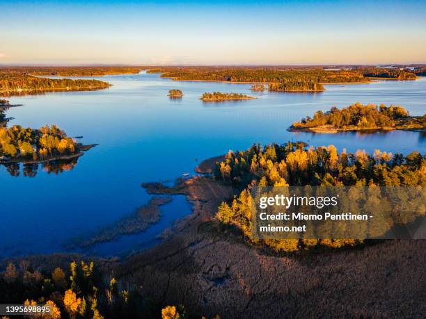 aerial view over autumnal coastal area near helsinki, finland during golden hour - archipelago ストックフォトと画像