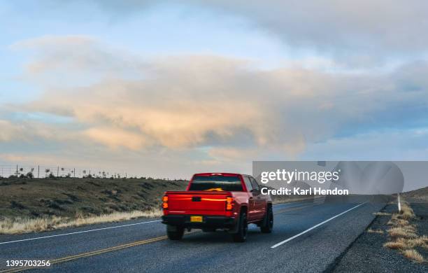 a pick-up truck on a desert road in new mexico at sunset - flatbed truck stock pictures, royalty-free photos & images