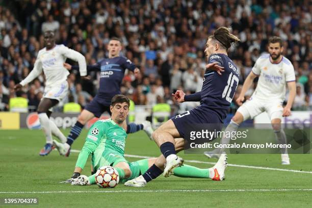 Goalkeeper Thibaut Courtois of Real Madrid CF stops the strike of Jack Grealish of Manchester City FC during the UEFA Champions League Semi Final Leg...