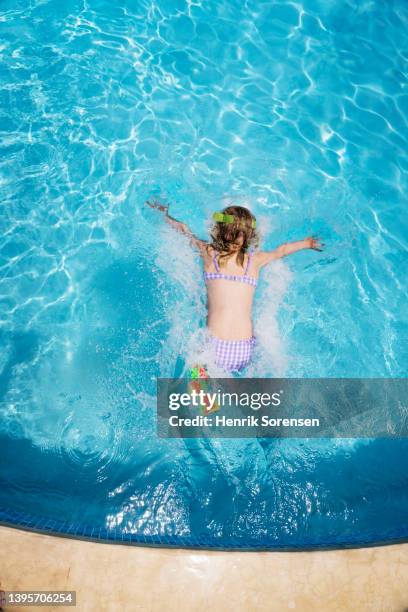 girl in swimming pool - swimming stroke stock pictures, royalty-free photos & images