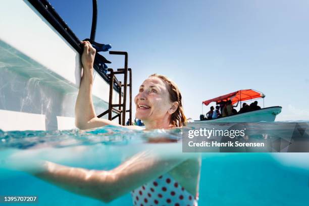 woman snorkling in the ocean - older woman wet hair stock pictures, royalty-free photos & images