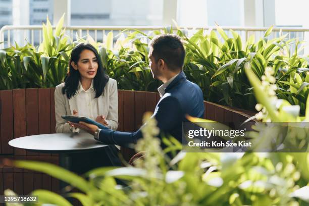 successful business - indian business man and woman in an outdoor meeting - indian economy business and finance stock pictures, royalty-free photos & images
