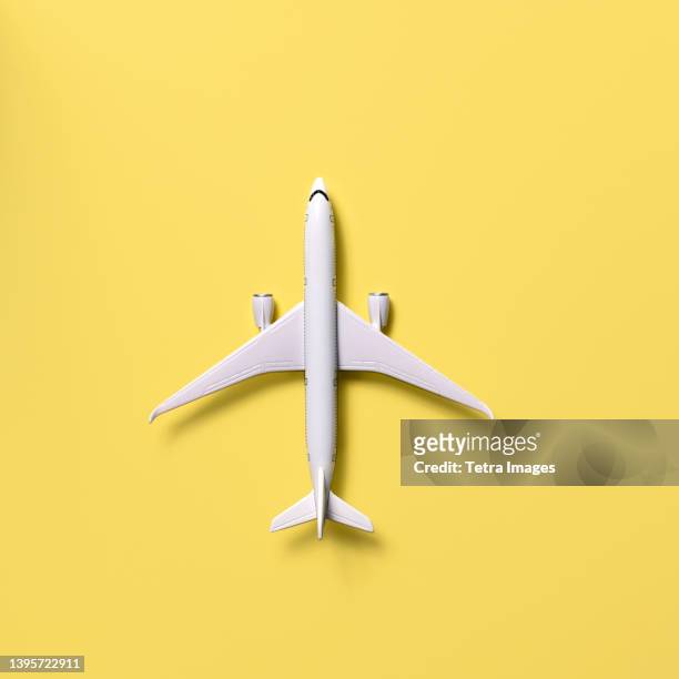 overhead view of airplane model against yellow background - modellflygplan bildbanksfoton och bilder