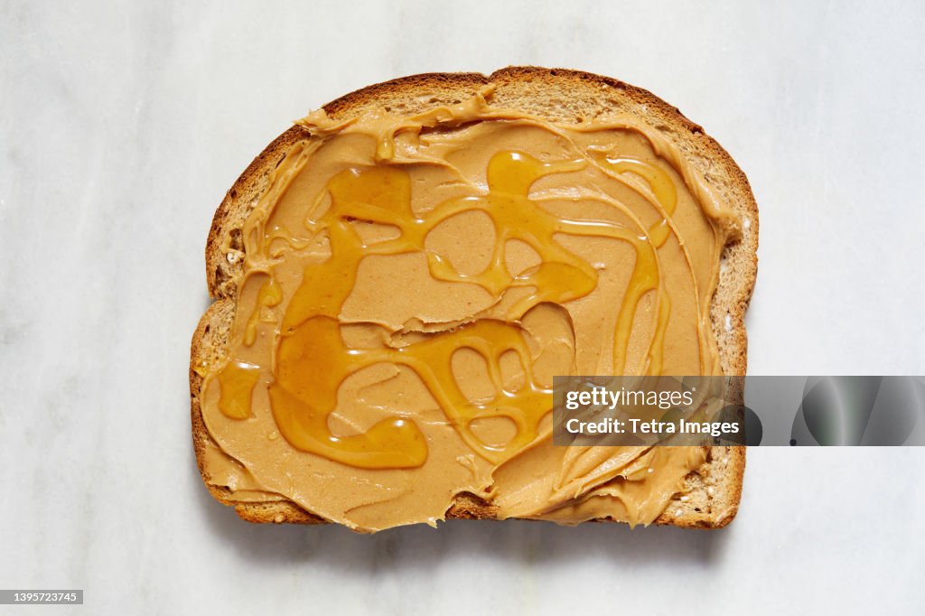 Overhead view of toast with peanut butter and honey