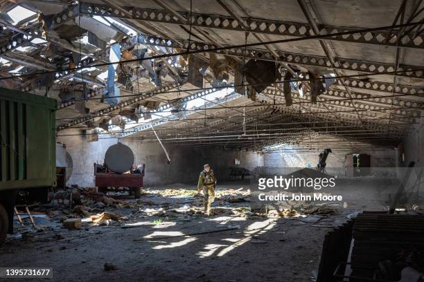 Ukrainian army officer inspects a grain warehouse earlier shelled by Russian forces on May 06, 2022 near the frontlines of Kherson Oblast in...