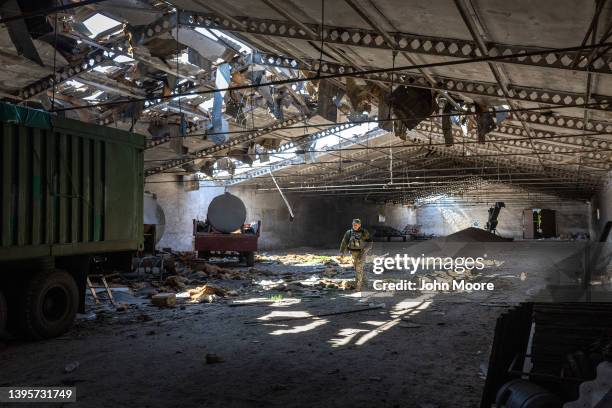 Ukrainian army officer inspects a grain warehouse earlier shelled by Russian forces on May 06, 2022 near the frontlines of Kherson Oblast in...