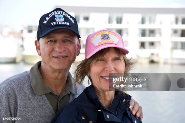 u.s. coast guard veteran couple retired, smiling looking at camera - military wife stock pictures, royalty-free photos & images