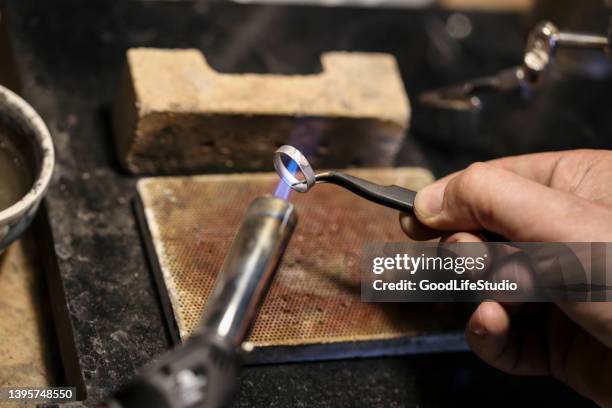 jeweller welding a ring - jeweller bildbanksfoton och bilder