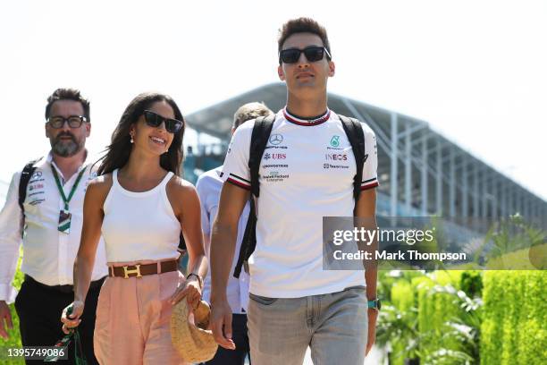 George Russell of Great Britain and Mercedes walks in the Paddock with his girlfriend Carmen Montero Mundt prior to practice ahead of the F1 Grand...