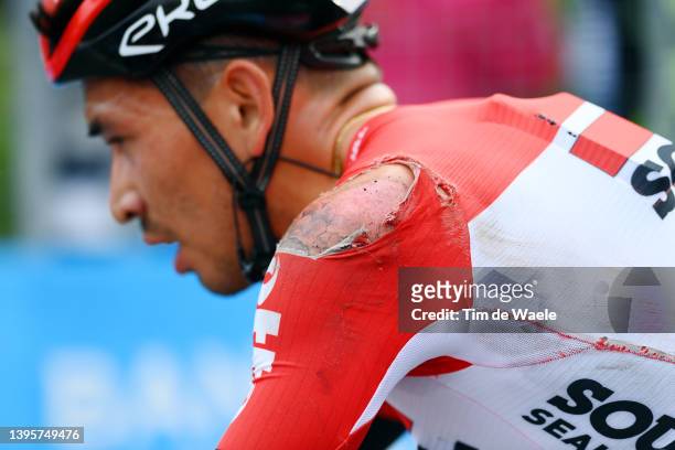 Caleb Ewan of Australia and Team Lotto Soudal crosses the finish line injured after being involved in a crash during the 105th Giro d'Italia 2022,...