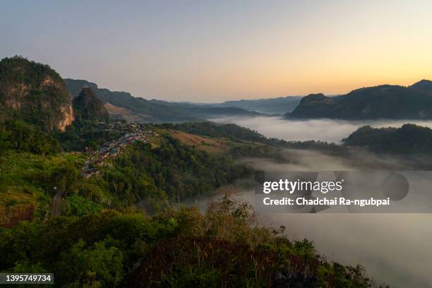 landscape photography of nature, mountains and fog in the morning at ja bo village at phu pha mok, mae hong son province, thailand. - mok stock pictures, royalty-free photos & images