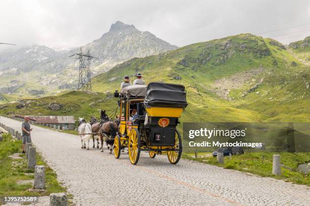 the legendary horse-drawn mail coach on the gotthard pass - horse and cart deliver stock pictures, royalty-free photos & images