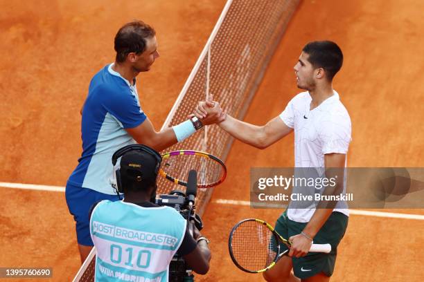 Carlos Alcaraz Garfia of Spain and Rafael Nadal of Spain interact following their quarter-final match during day nine of Mutua Madrid Open at La Caja...