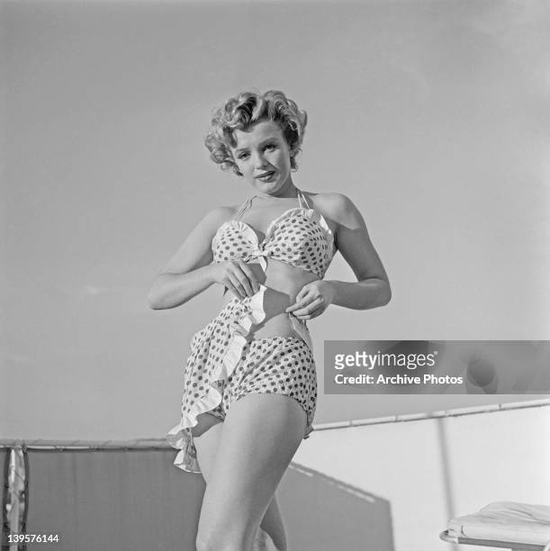 American actress Marilyn Monroe wearing a polka dot bikini with a matching wraparound miniskirt, circa 1951.