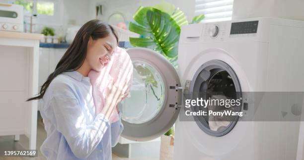 woman take clothes from washer - towel stockfoto's en -beelden