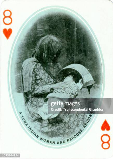 View of an 'Eight of Hearts' that features a member of the Yuma tribe as she holds an infant in a papoose from a deck of playing cards, 1911. It was...