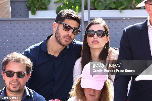 Marcos Asensio and his girlfriend Sandra Garal are seen during the match between Rafael Nadal and Carlos Alcaraz of Spain during the Mutua Madrid...