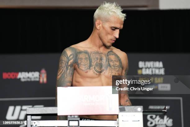 Charles Oliveira of Brazil reacts after failing to make weight, vacating the UFC lightweight championship, during the UFC 274 official weigh-in at...