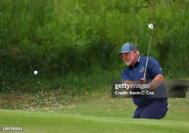 Darren Clarke of the Bahamas plays a shot on the ninth hole during round one of the Mitsubishi Electric Classic at TPC Sugarloaf Golf Course on May...