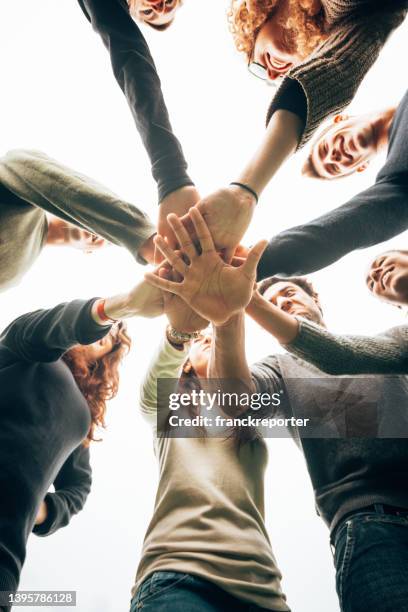 friends all together in a team - hand stack stock pictures, royalty-free photos & images